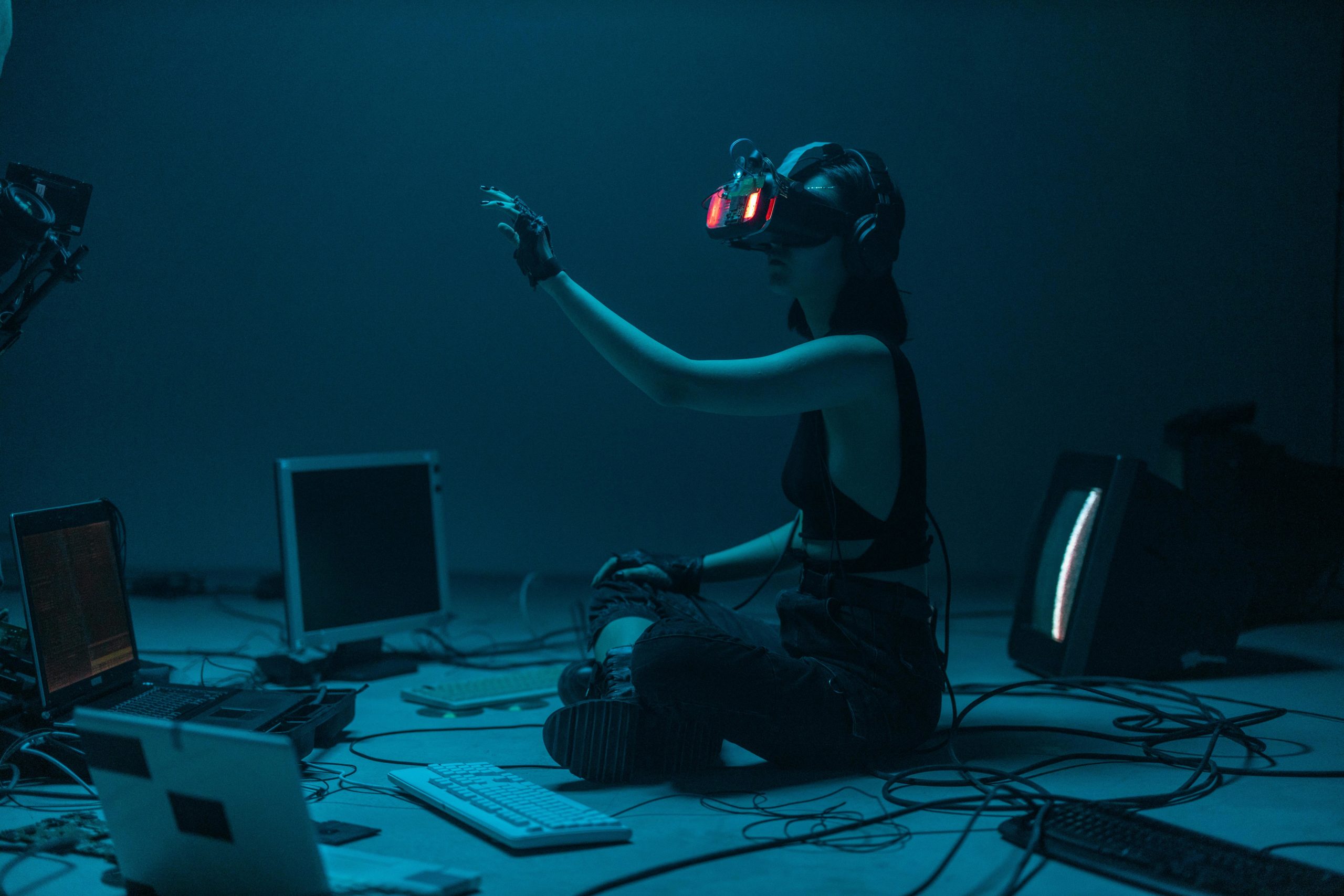VR-equipped woman in a futuristic tech space, representing AI and property managers leveraging innovation to support property management.